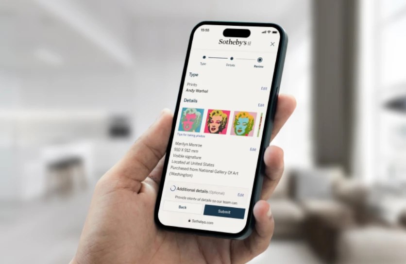 Hand holding iphone with Sotheby's estimate tool showing