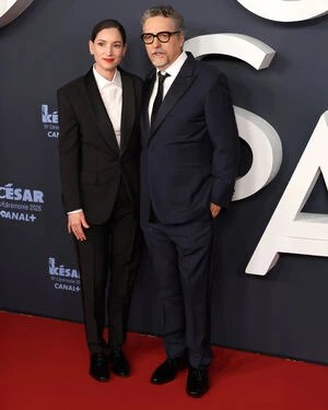 Laurent Lafitte holding his 2026 Best Actor César award in a Berluti tuxedo.