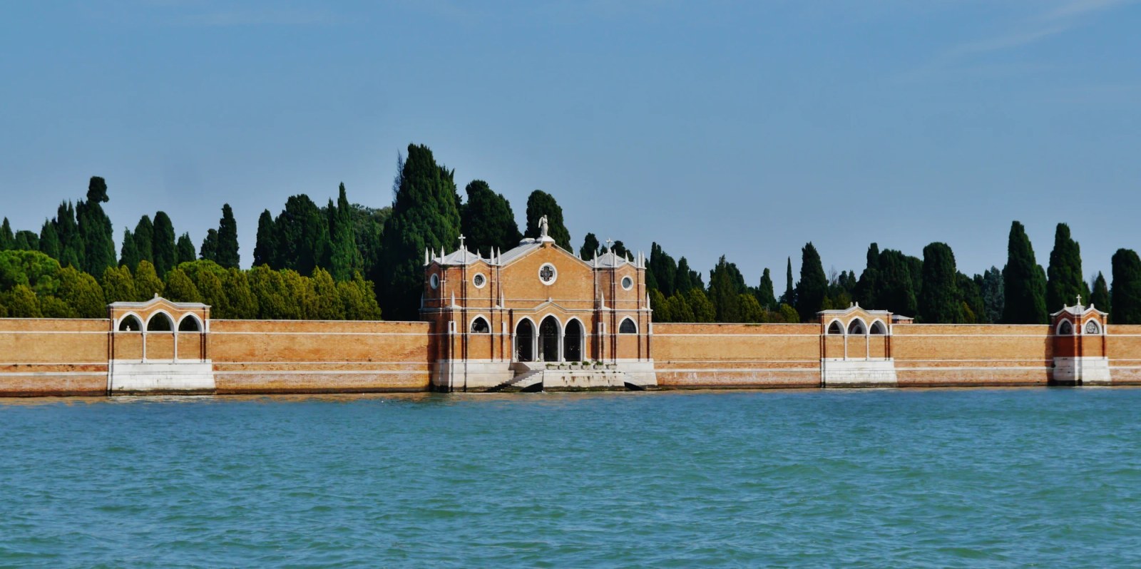 ## **Isola di San Michele** | The island cemetery San Michele, encircled by terra cotta brick walls and cypress trees. Photo by [Anton Nosik](https://en.wikipedia.org/wiki/en:Anton_Nossik), [CC BY 3.0](https://creativecommons.org/licenses/by/3.0/)