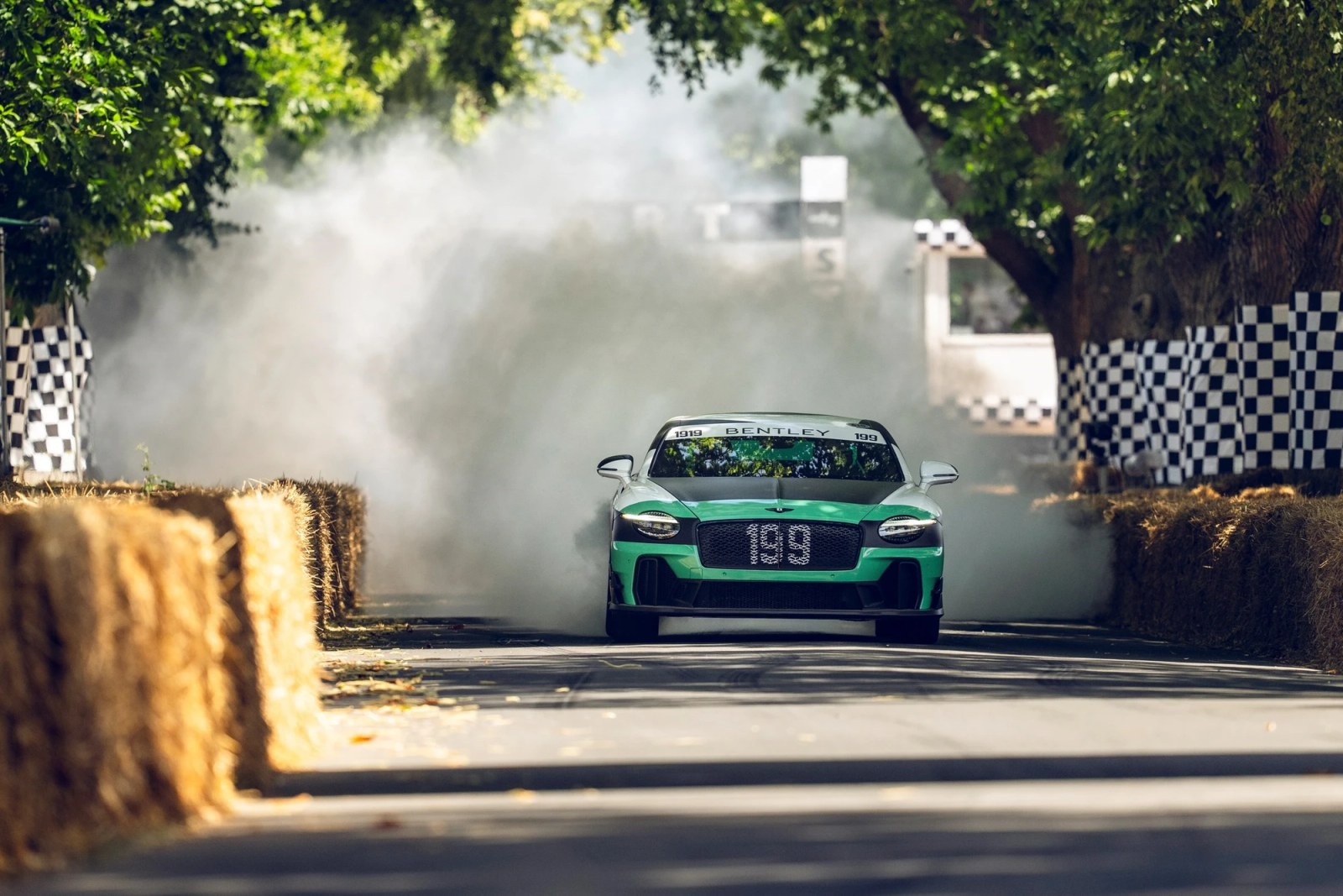 The Bentley Supersports seen from the rear with smoke billowing.
