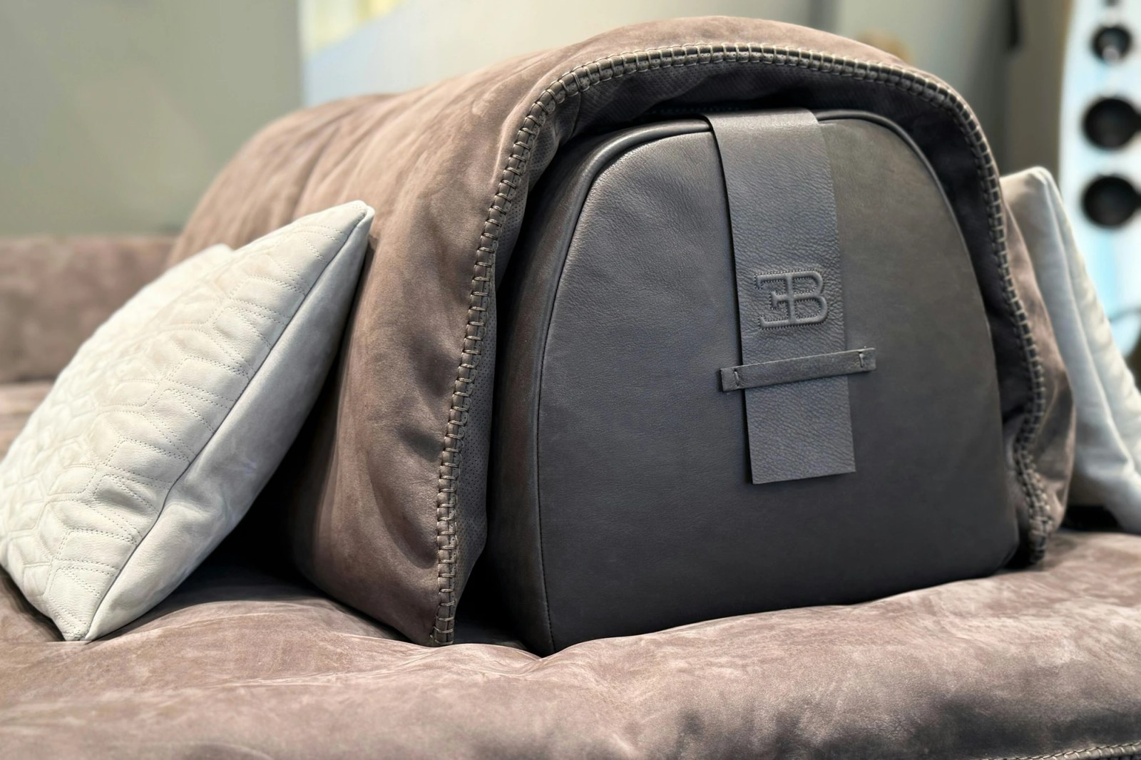 A close-up of the leather strap on the TYPE_21 sofa, a nod to Bugatti's automotive codes.