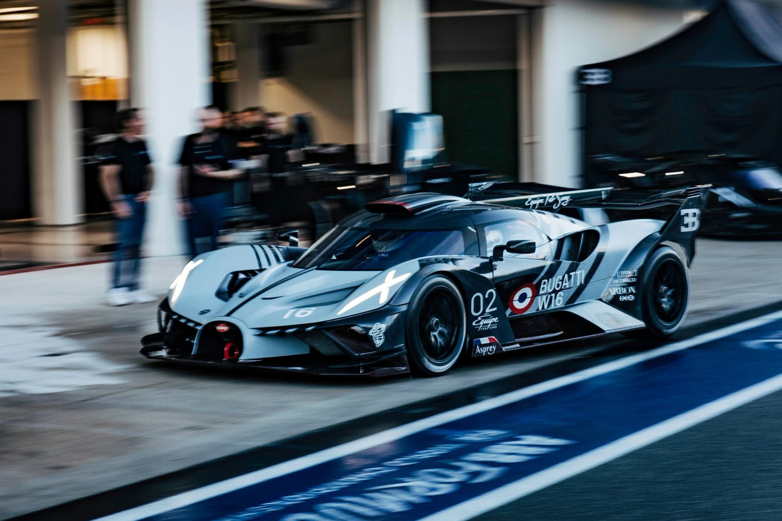 A Bugatti specialist prepares a Bolide for its driver on track