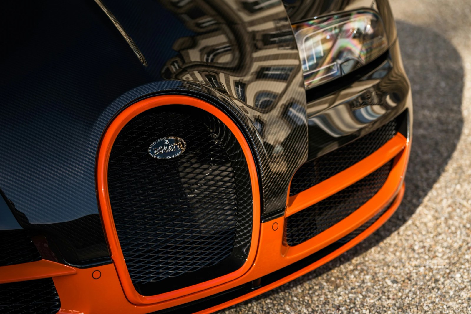 The exposed carbon fiber bodywork of the Bugatti Veyron being refinished with a new clear-coat.