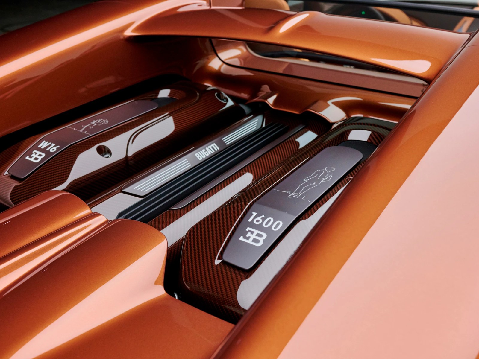 Unique engravings of characters from the book adorn the engine bay of the Sur Mesure Bugatti W16 Mistral.