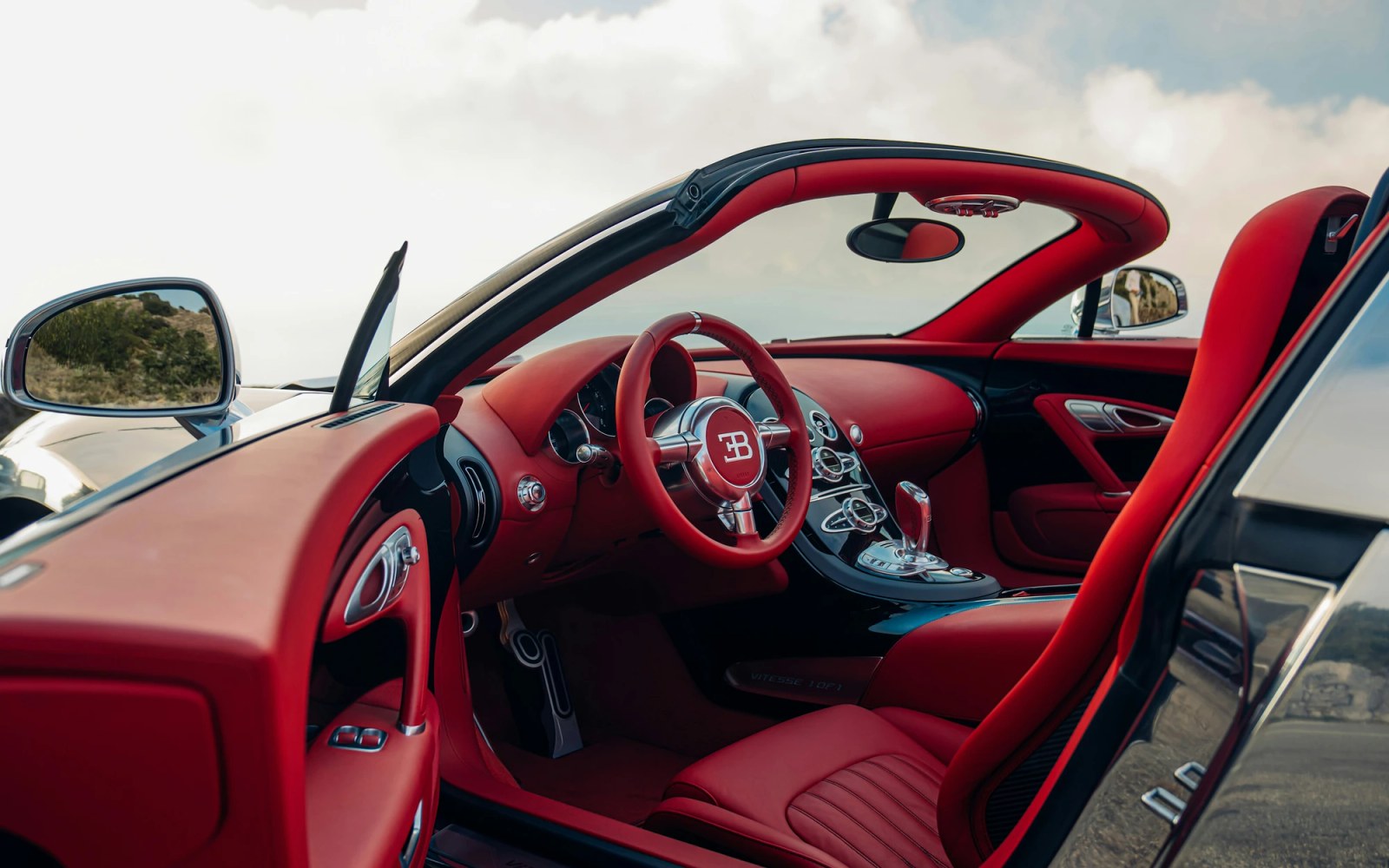 Interior detail of the restored Bugatti Veyron showing the Carmine Red leather and aluminum trim.
