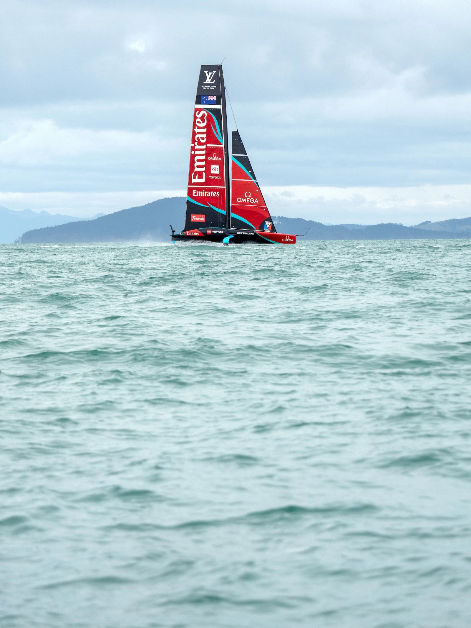 OMEGA watch with a sailboat in the background for the America's Cup