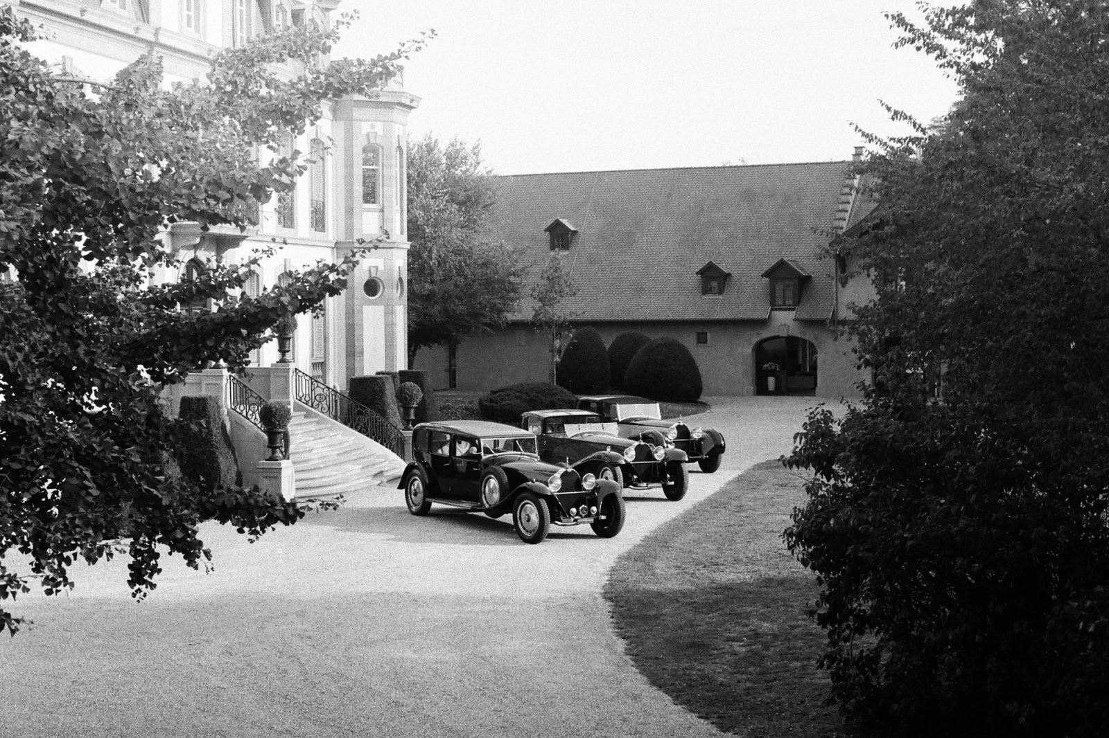 Three Bugatti Royale examples parked on gravel