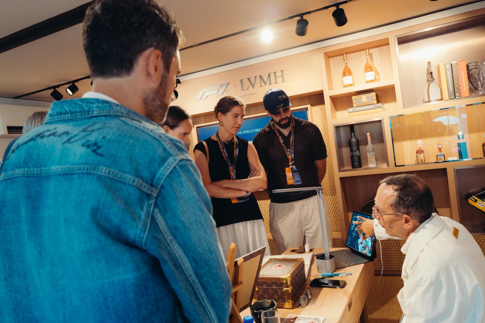 An artisan from an LVMH Maison demonstrating their craft inside the paddock.
