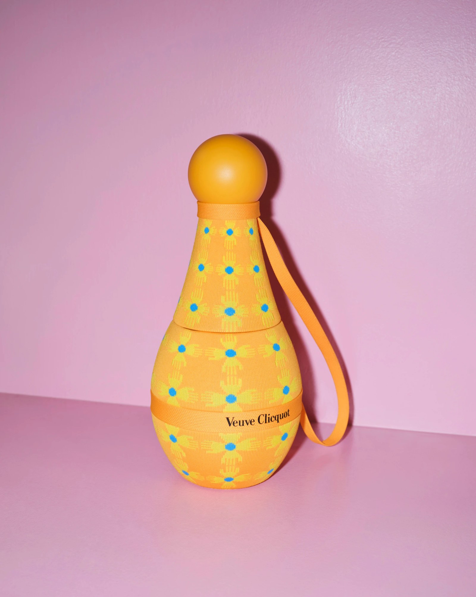 Close-up of a Veuve Clicquot Rosé bottle next to its brightly colored Yinka Ilori designed gift box.