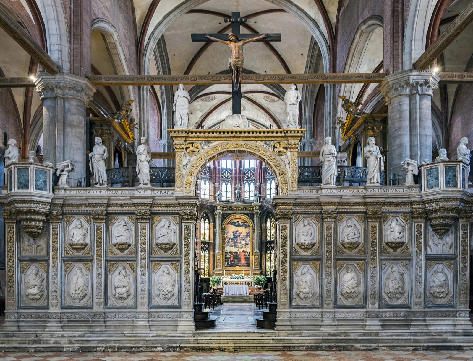 ## **Basilica di Santa Maria Gloriosa dei Frari** | Titian’s “Assumption of the Virgin” seen through the choir-screen at the Basilica di Santa Maria Gloriosa dei Frari. Photo by [Didier Descouens](https://commons.wikimedia.org/wiki/User:Archaeodontosaurus), CC BY-SA 4.0