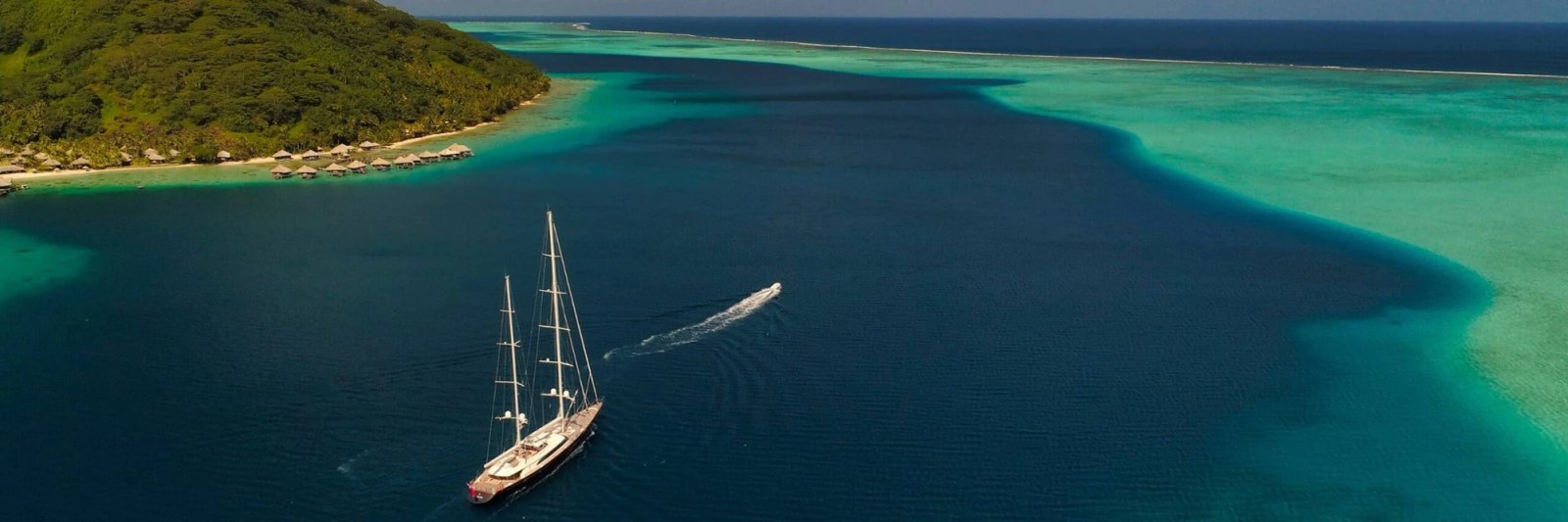 A yacht anchored in the clear turquoise waters of French Polynesia