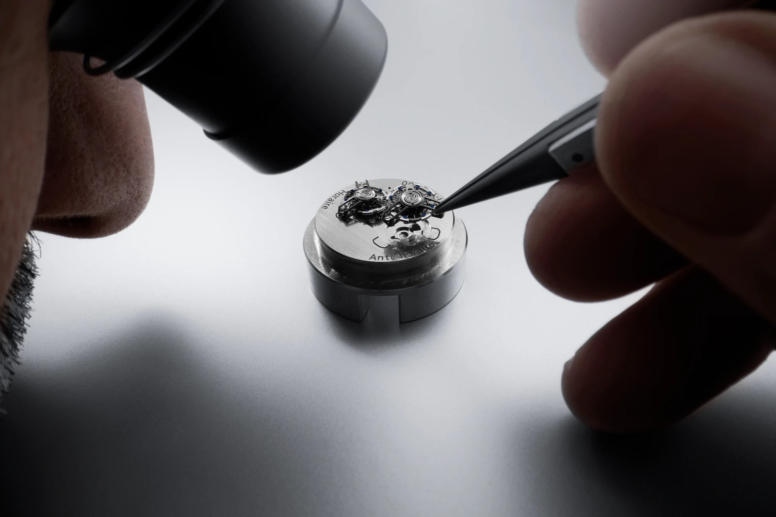 A watchmaker assembling the complex movement of the Ulysse Nardin [Super] Freak.